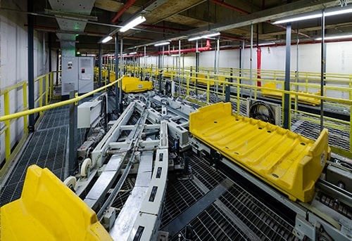 Industrial workshop with yellow machinery and equipment.