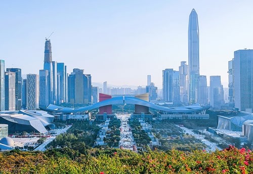 Vibrant cityscape with modern skyscrapers, towering buildings, and a central plaza in Shenzhen, China.