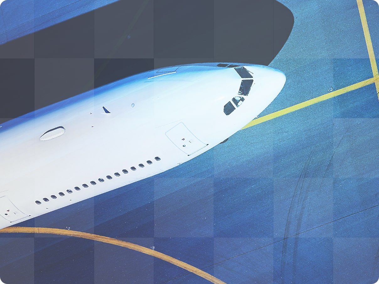 Close-up view of a commercial aircraft nose on the tarmac.